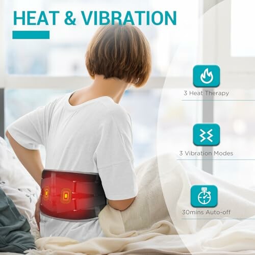 Person using heat and vibration therapy belt for back pain relief.
