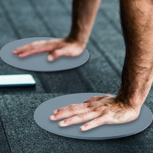 Person using exercise sliders on a gym floor