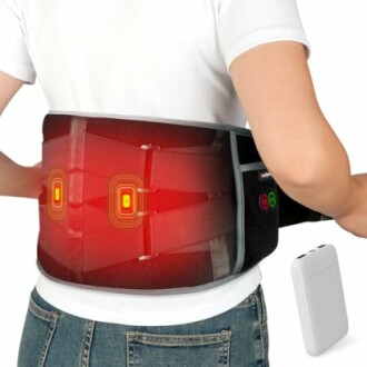 Person wearing a heated back support belt with adjustable straps and remote control.